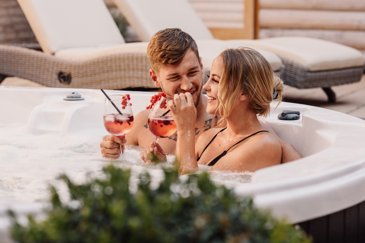 A couple enjoying themselves in a hot tub.
