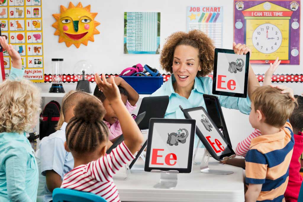 Teacher and students learn letters in a kindergarten class.