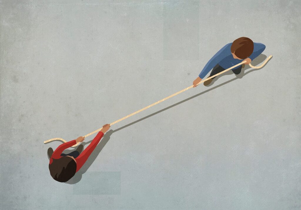 An illustration of a person in a red shirt and a person in a blue shirt playing tug-of-war. Shown from overhead.