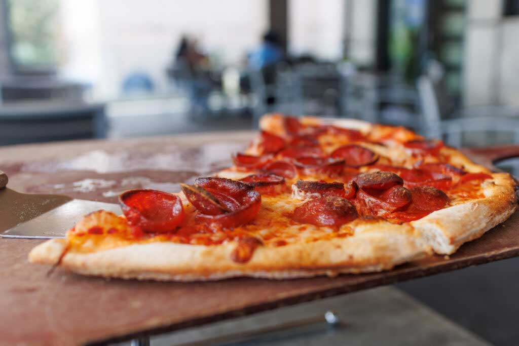 Leftover pizza is sitting out on the counter.