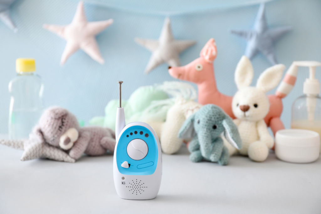 Baby audio monitor surrounded by soft toys.