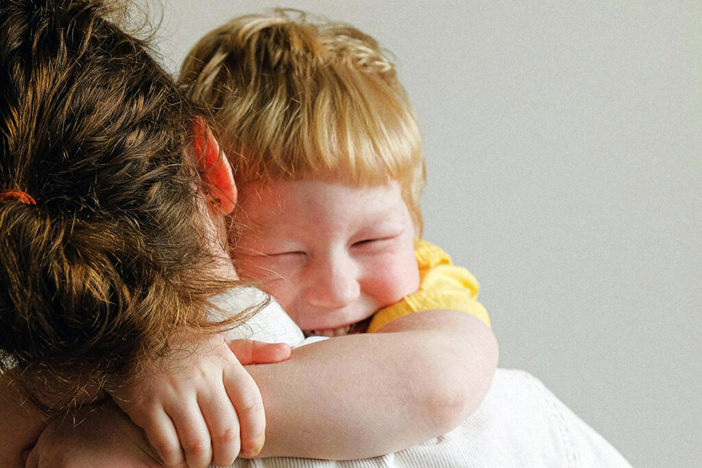 A child hugging the parent