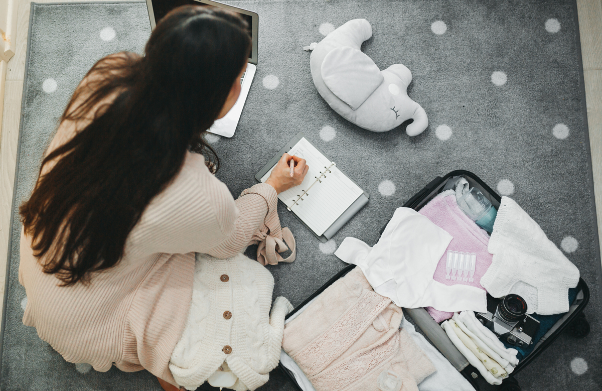 A view of a pregnant person packing a go-bag for delivery at the hospital.