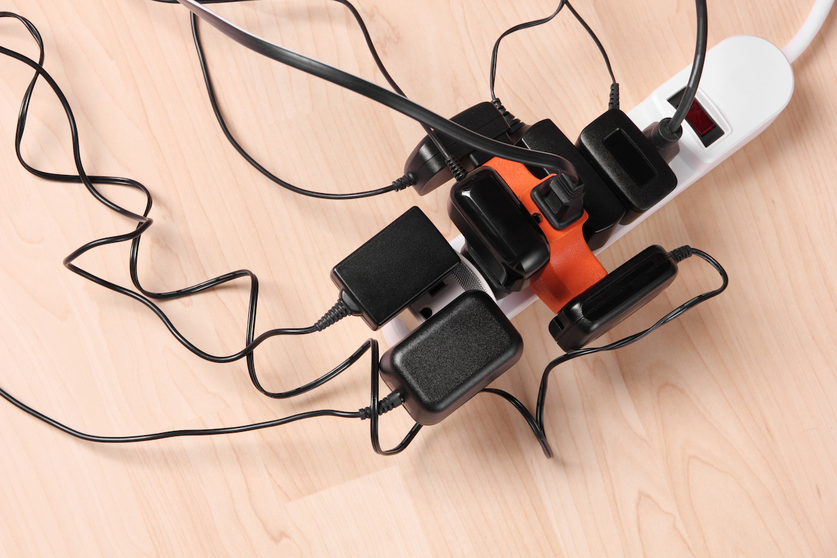 Too many phone chargers are plugged into an extension cord.