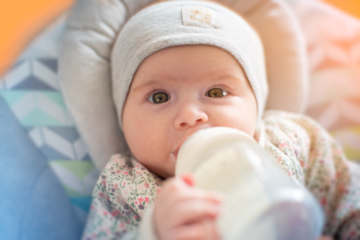 A baby drinking milk from a bottle