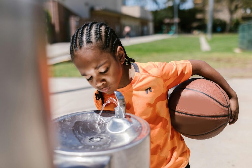 Child drinking at water fountain