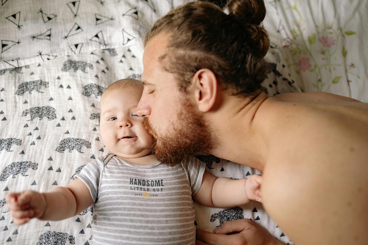 Parent kissing newborn