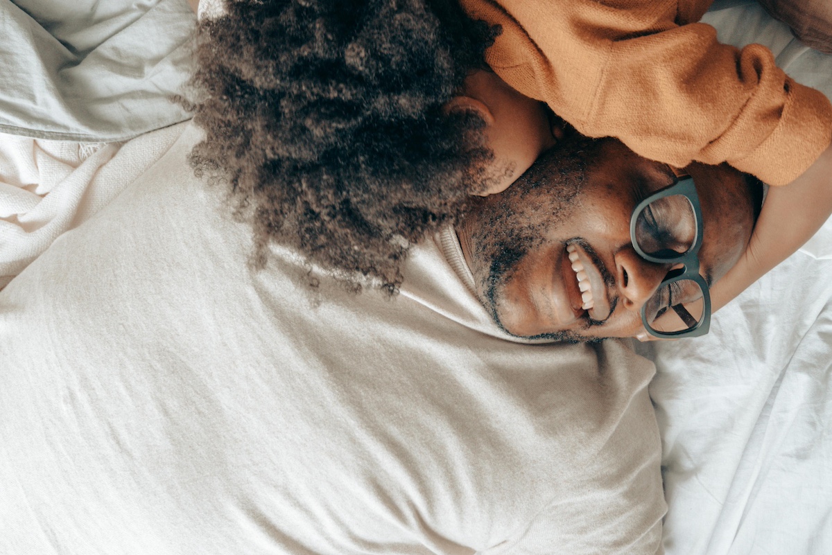 Parent and child cuddling in bed