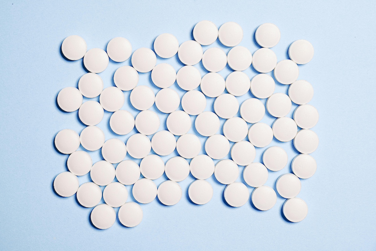 White pills on blue background