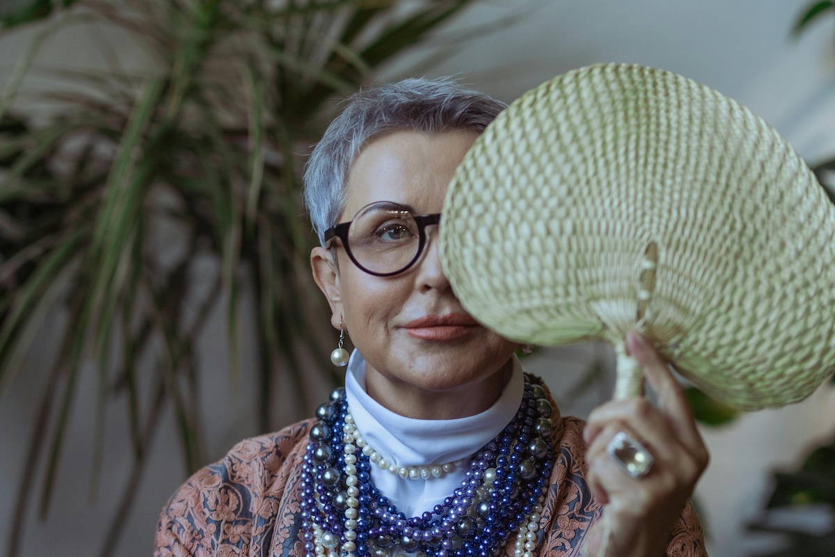 Person behind a handheld fan