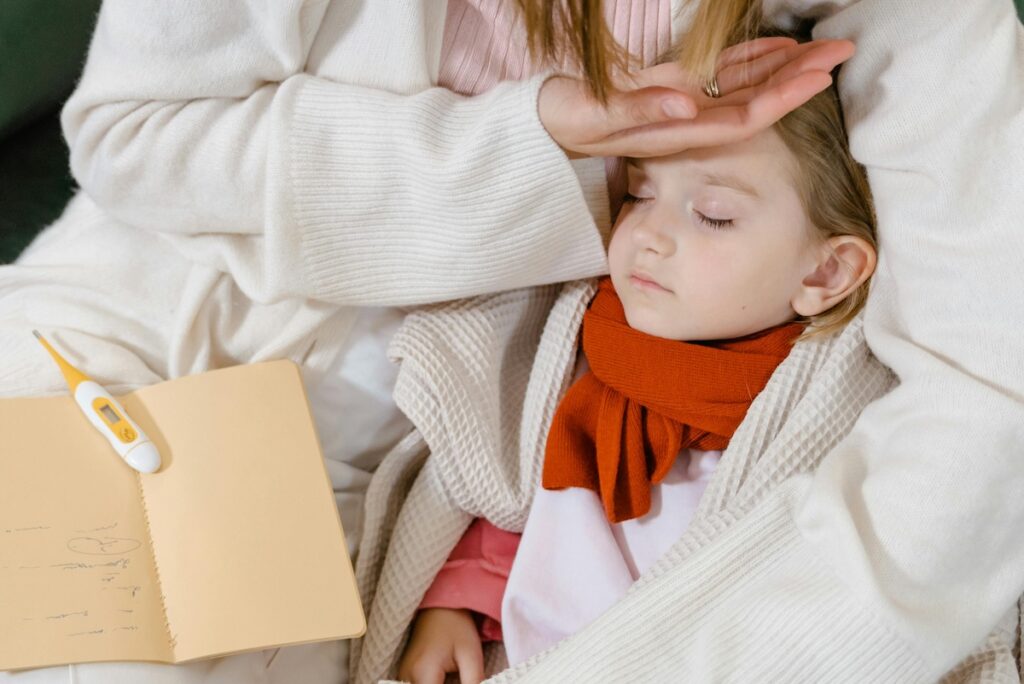 Parent uses back of hand to check child's temperature