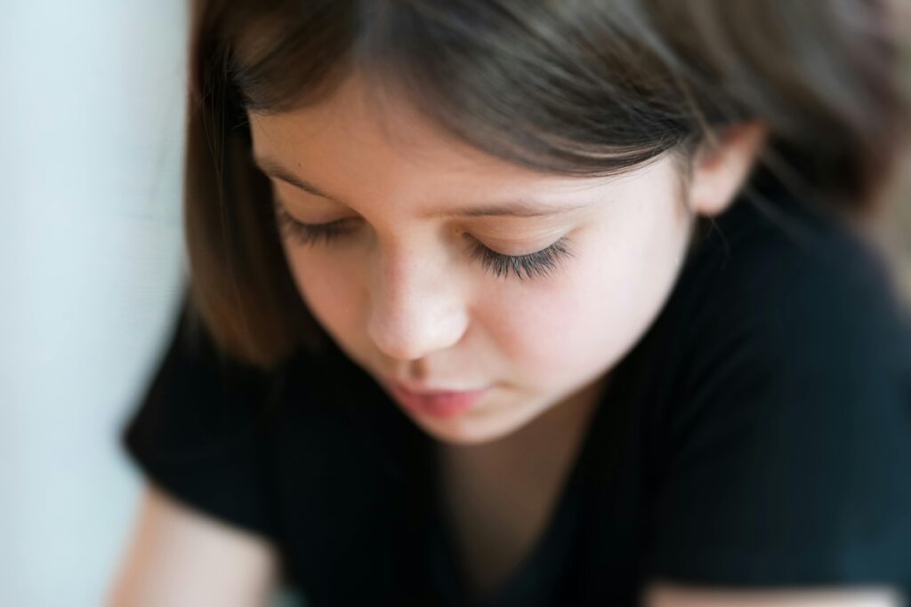 Child looking down with long eyelashes