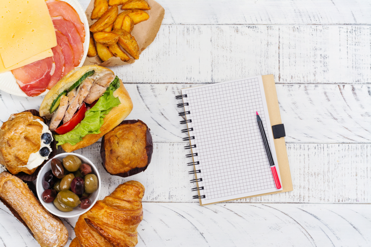Junk food on the side with a notebook and a pen.