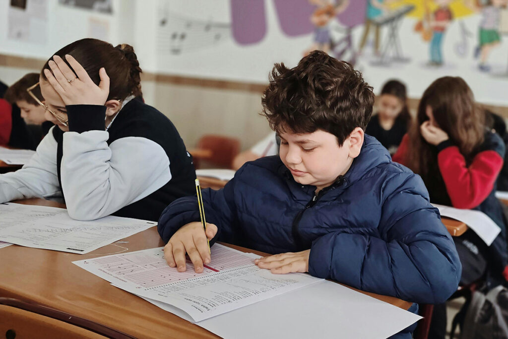 Kids writing in school.