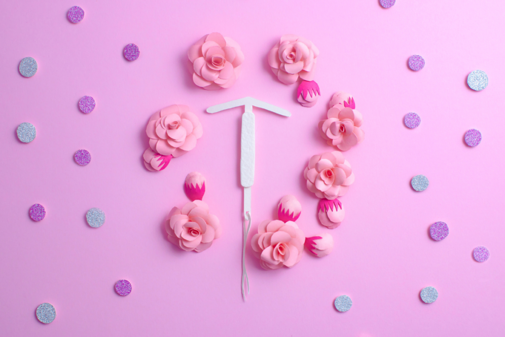 IUD and colorful pills made out of paper with flowers