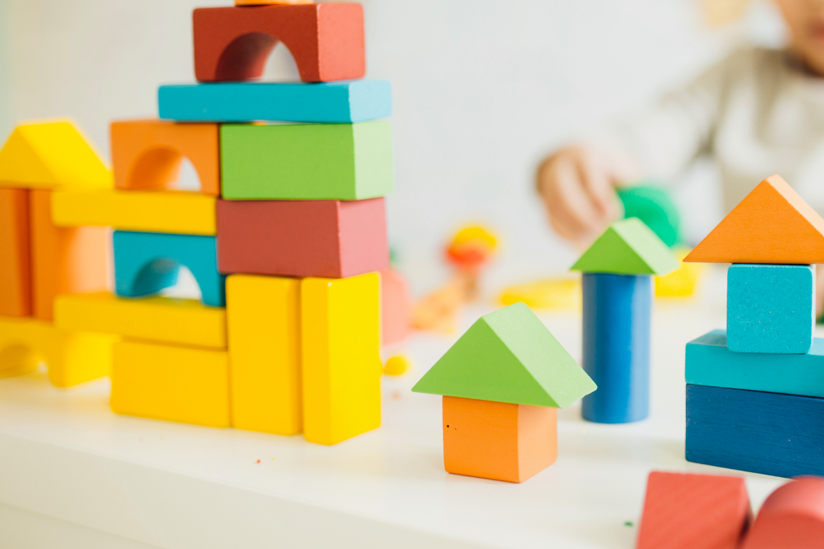 Child building with colorful blocks.