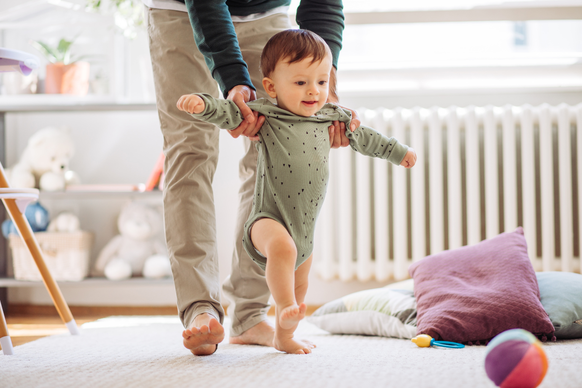 A parent helping a baby to walk