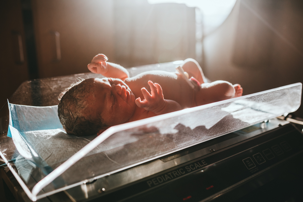 A newborn on a weighing scale