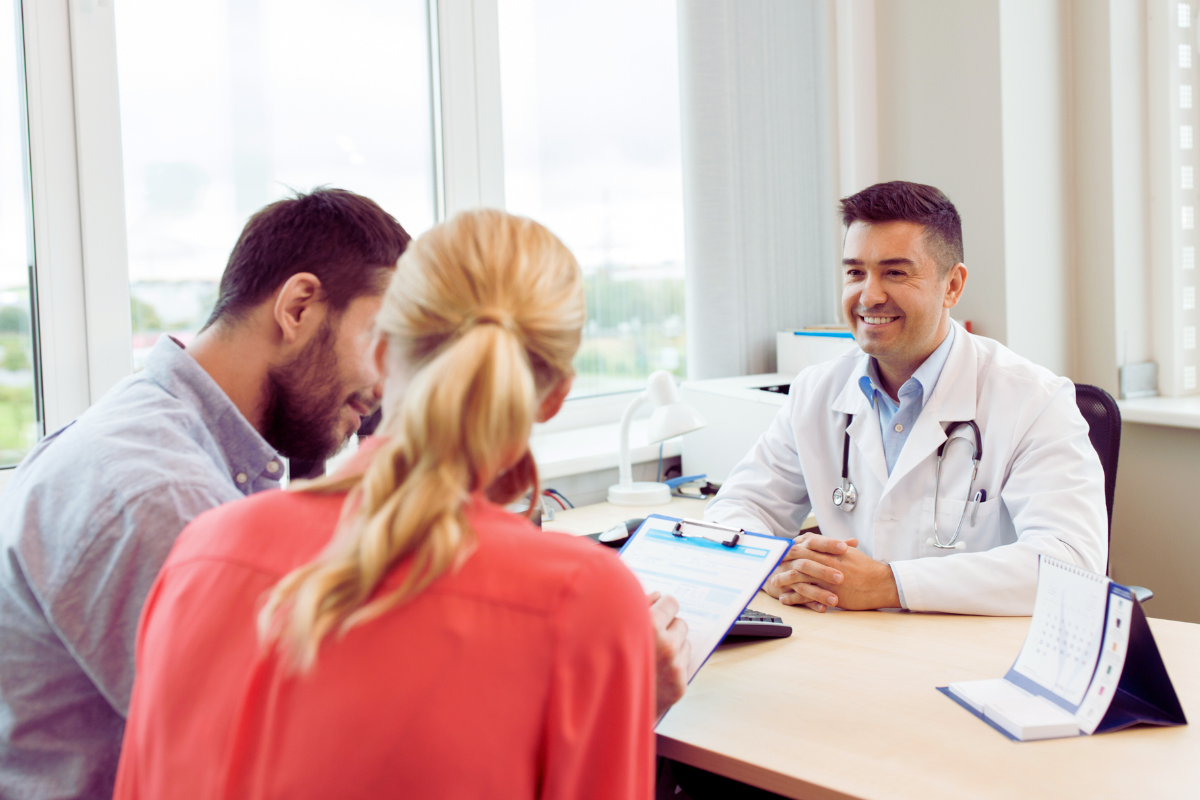 A doctor and a couple discussing.