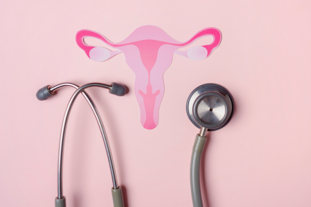 A stethescope and a paper cut out of uterus