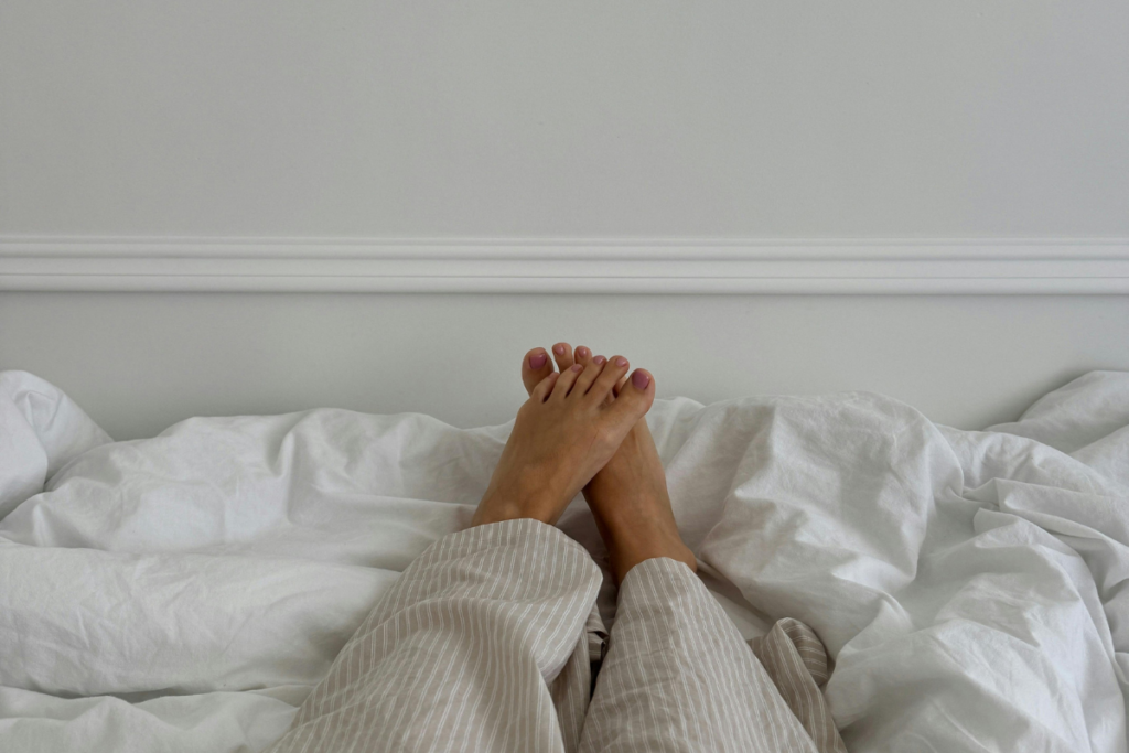 Zoom in of a person's les on bed