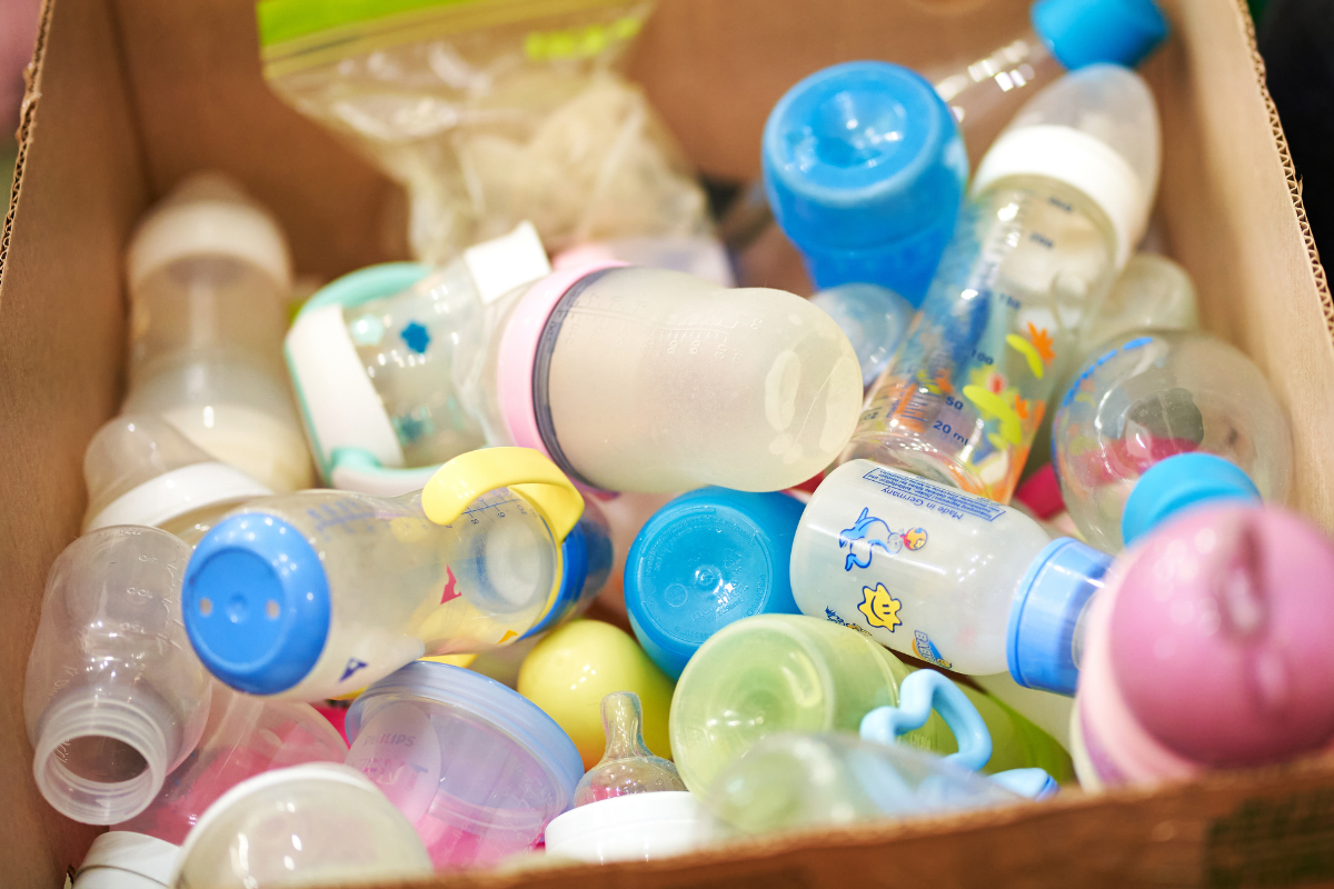 A box of used plastic baby bottles.