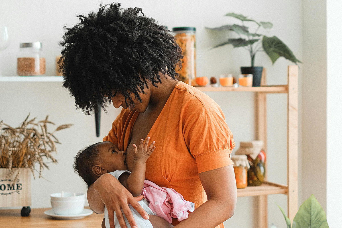 A parent breastfeeding a baby.