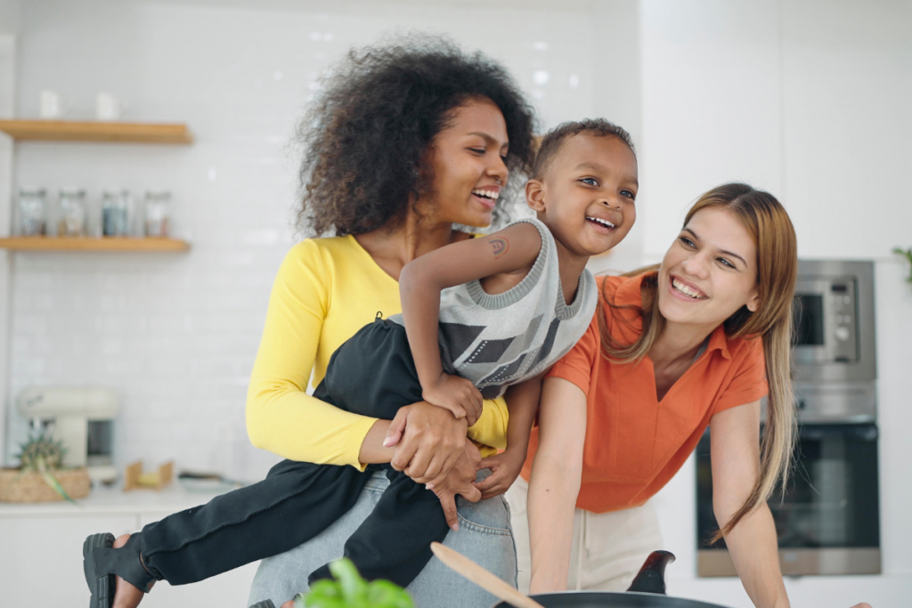 Two moms having fun with a son.