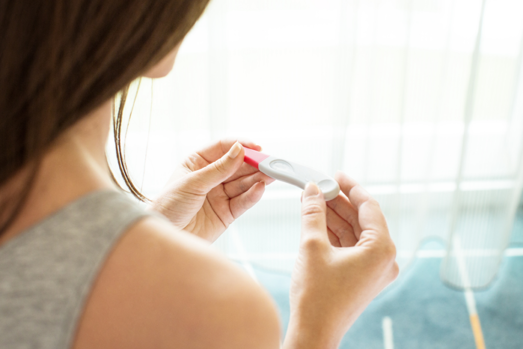 A person looking at a pregnancy test.