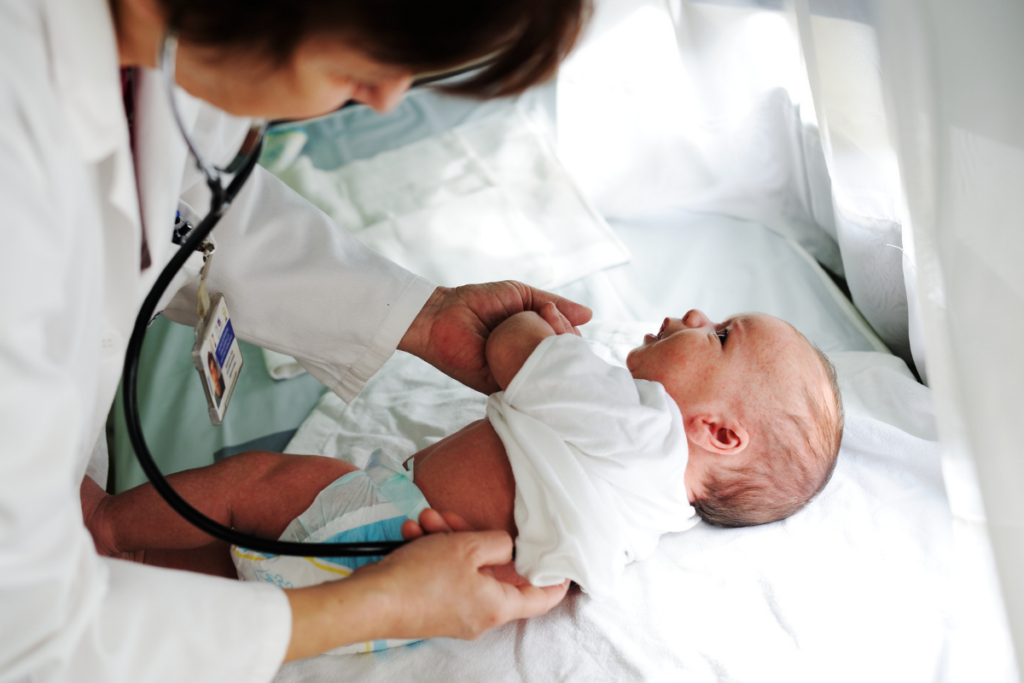 A doctor checking a new born.
