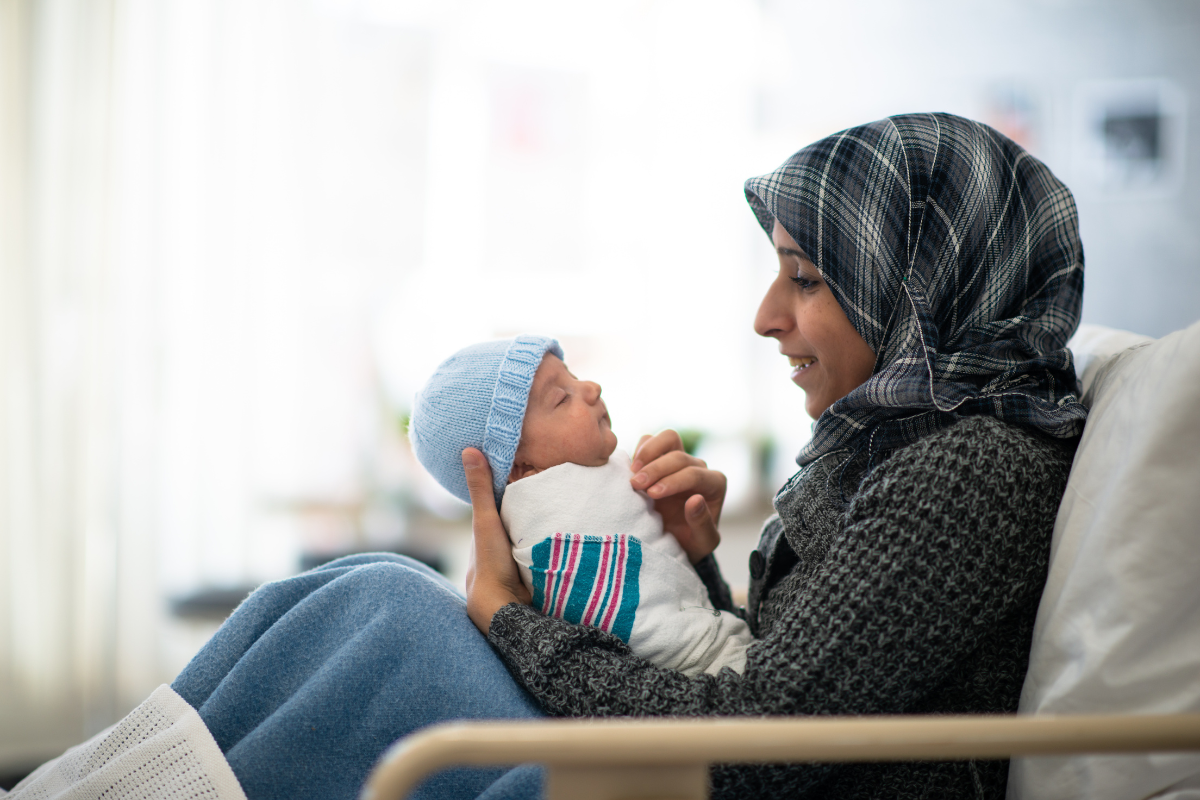 A parent holding her newborn baby.